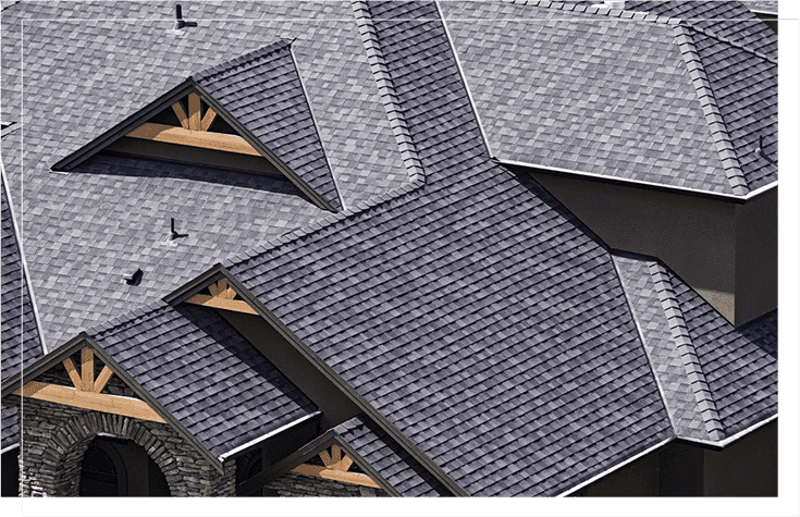 An aerial view of a roof with gray shingles.