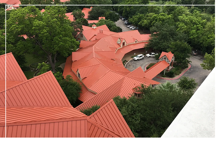A view of some red roofs from above.